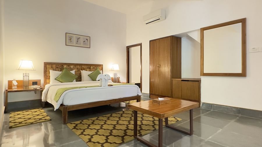 Sanctuary Suite at Saraca Resort & Spa Corbett with a double bed, side tables and a wardrobe
