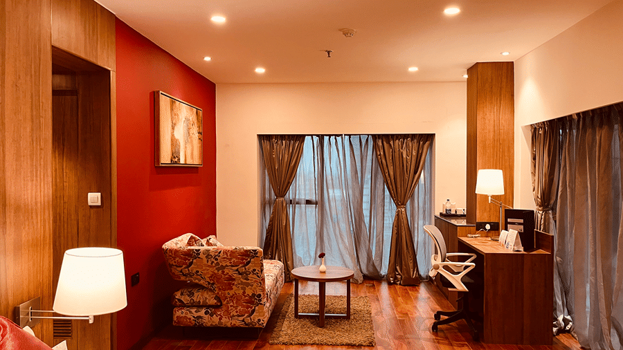 Full view shot of the Superior Smart Suite with warm lighting and wooden flooring at the Senses Hotel.