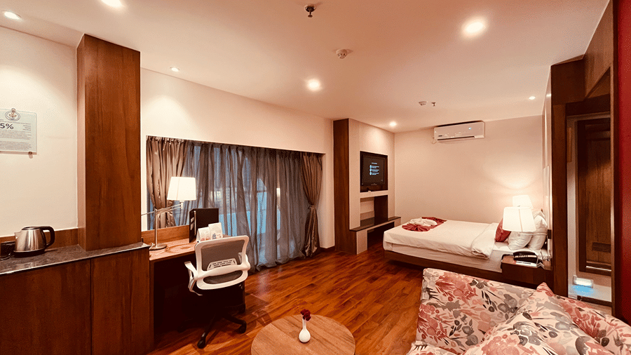 Full view shot of the Superior Smart Suite featuring the expansive room along with tall french windows covered with thin curtains at Senses Hotel.