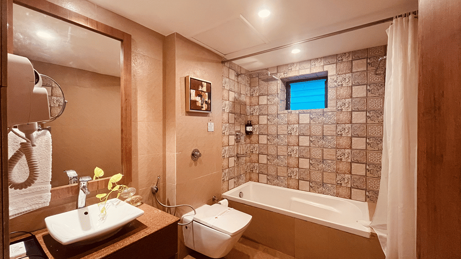 A luxurious bathroom at the Senses Hotel featuring a bathtub along with a vanity area.