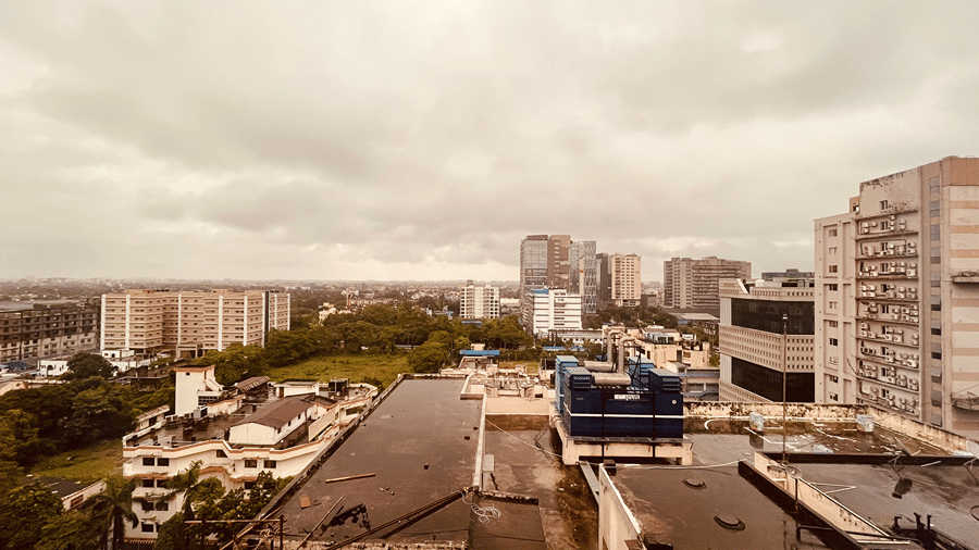 A beautiful landscape of Kolkata with a cloudy sky in the background from the balcony of the Superior Smart Suite.