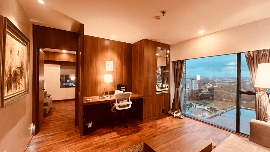 Corner view shot of the separate living area with huge wide windows overlooking lush green surroundings at the Senses Hotel.