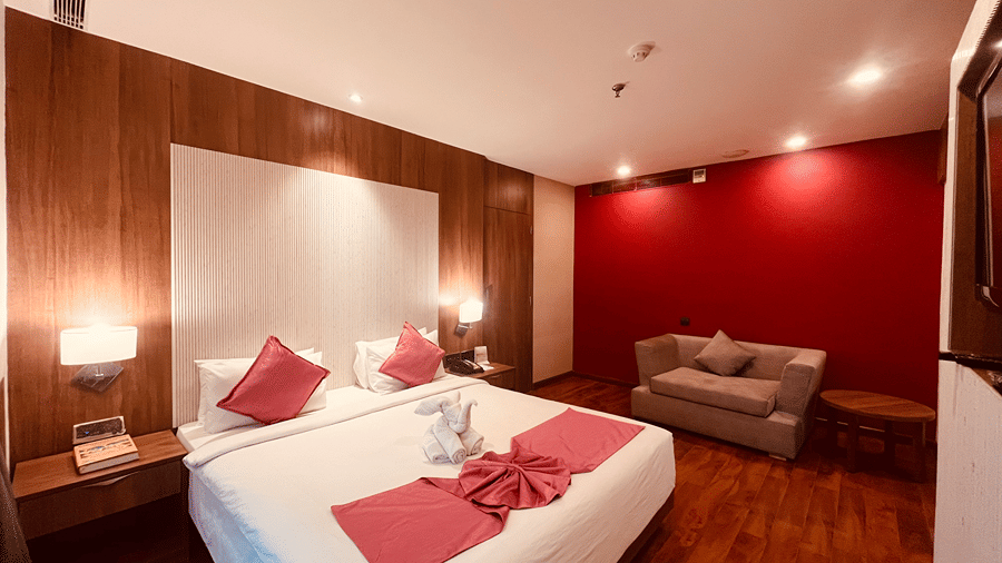 Corner view of the double bed at the premier Smart Suite at the Senses Hotel with a small couch in the corner at the Senses Hotel.