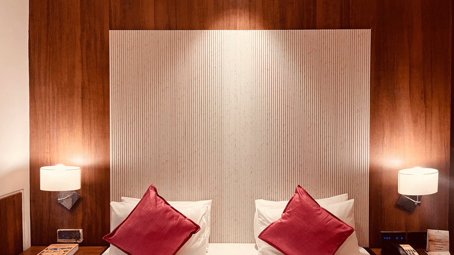 Front view of the double bed with soft pillows and cushions kept over it at the Premier Smart Suite at the Senses Hotel.