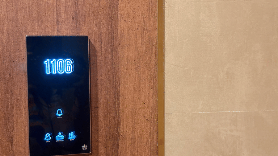 Hotel room number plate displaying room number, bell icon and other options on modular electronic touch switches at Senses hotel.