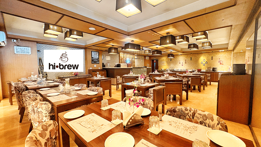 A wide angle shot of the Hi Brew restaurant with warm lighting at the Senses Hotel.
