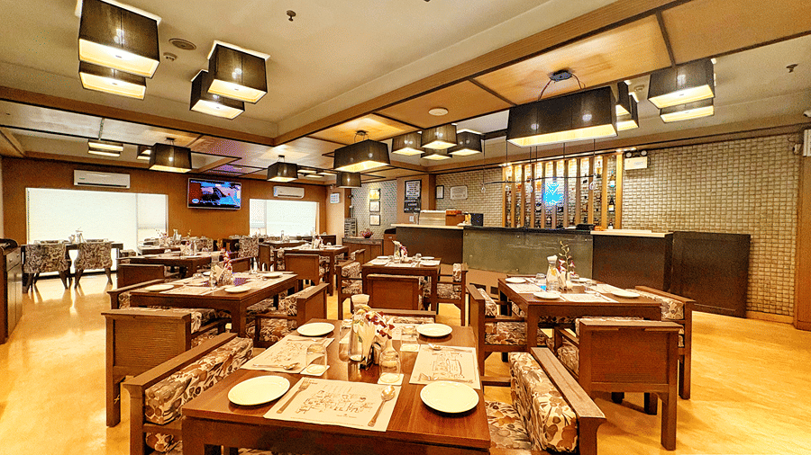 A close up shot of a dining table with well arranged cutlery and paper table mats at the Senses Hotel.