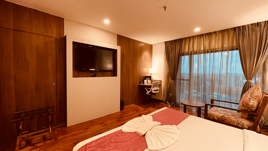 Corner view shot of the Superior Room overlooking the double bed along with a wall mounted television opposite to it - Senses Hotel