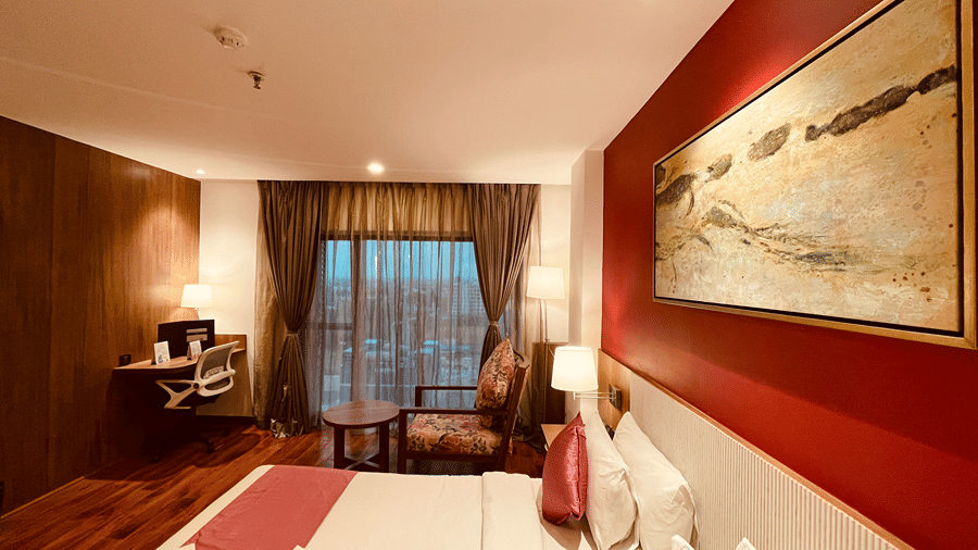Side view of the Superior Room with a double bed along with a huge window with beautiful evening views - Senses Hotel