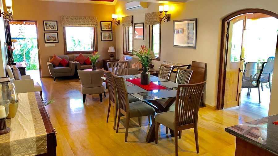 Living Area featuring a six-seater dining table behind which sofa sets are arranged