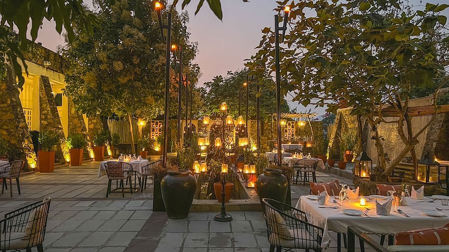 An image of an outdoor seating at the hotel with decorative lighting - Utsav Camp Sariska