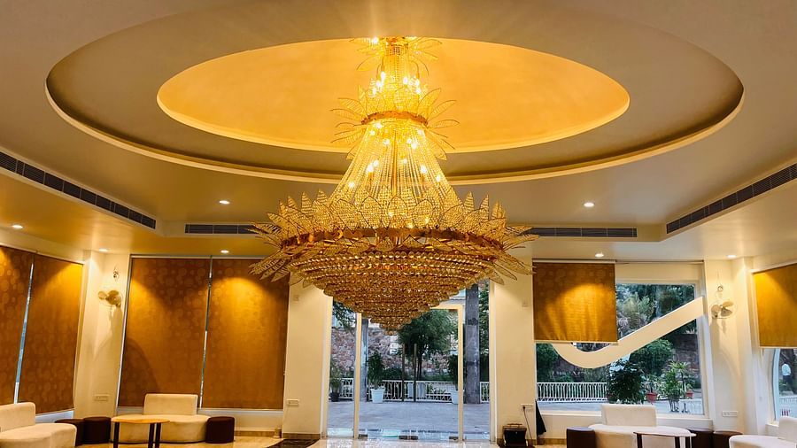 A large chandelier with seating area in the background at Valley by Grassfield.