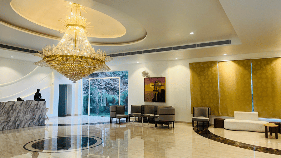 Lobby with a grand chandelier at Valley by Grassfield, a resort in Jaipur.
