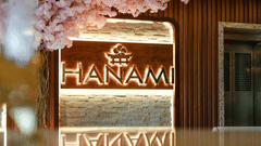 Entrance of Hanami Pan-Asian Restaurant at Uday Suites, adorned with floral decor and warm lighting.