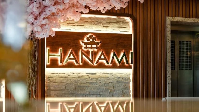 Entrance of Hanami Pan-Asian Restaurant at Uday Suites, adorned with floral decor and warm lighting.