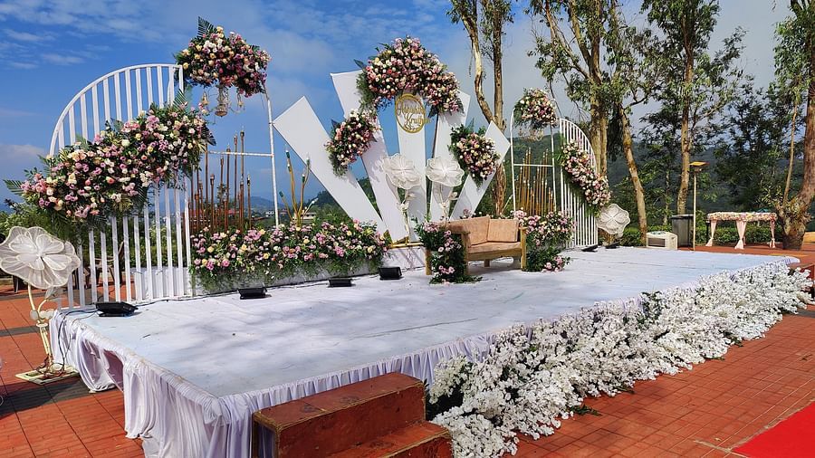 Outdoor reception area with decorated tables and floral backdrops | Open Deck