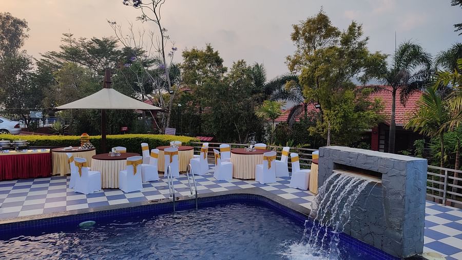 Outdoor event space featuring a pool and seating areas | Open Deck | Woodstock Resorts, Coorg