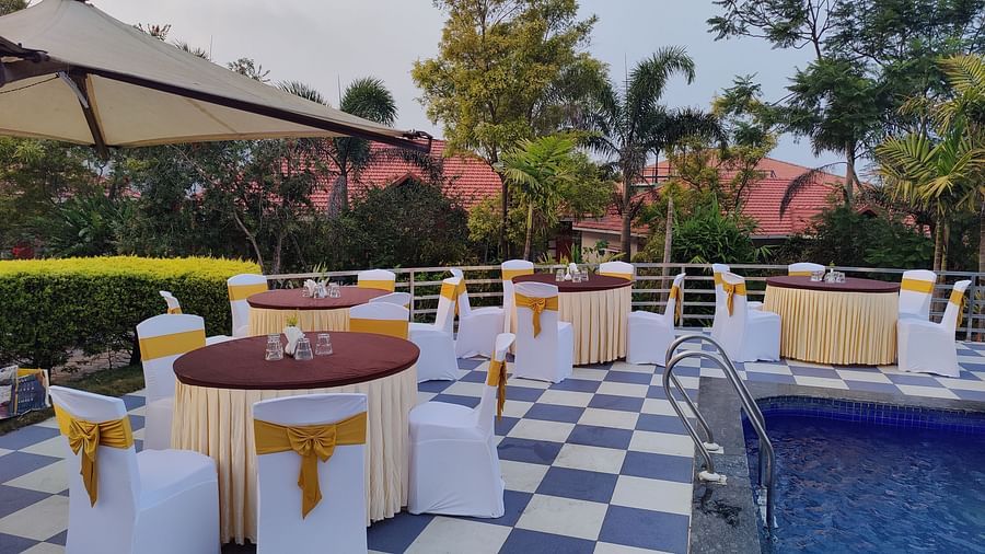 Outdoor event space with round tables and a swimming pool | Open Deck