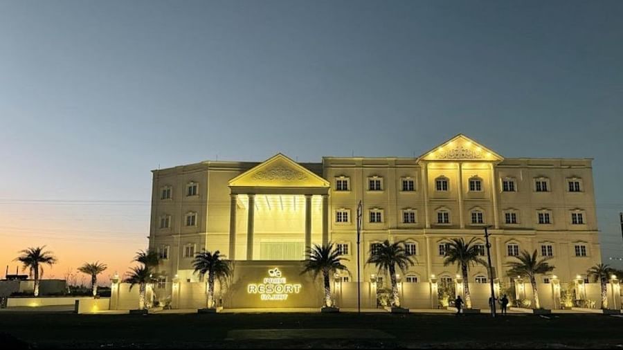 Shot of the resort taken during late evening featuring a swimming pool in the side - Pride Resort, Rajkot