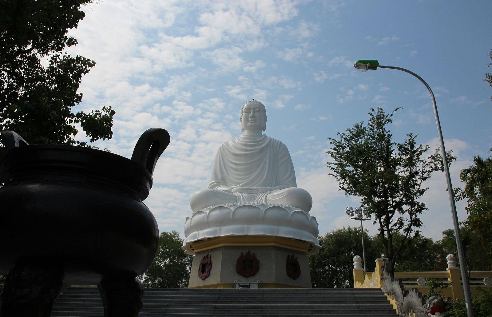 A low angle image of a huge Buddha state at Long Son Pagoda.