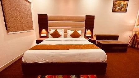The executive room showcasing a bed, bedside tables, and a sofa cum bed - Five Elements Hotels, Haridwar