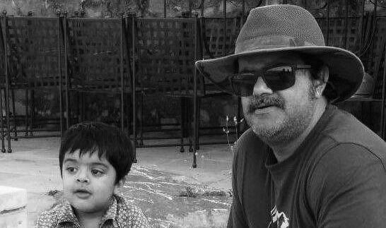 A black and white image of Luv Shekhawat with a toddler