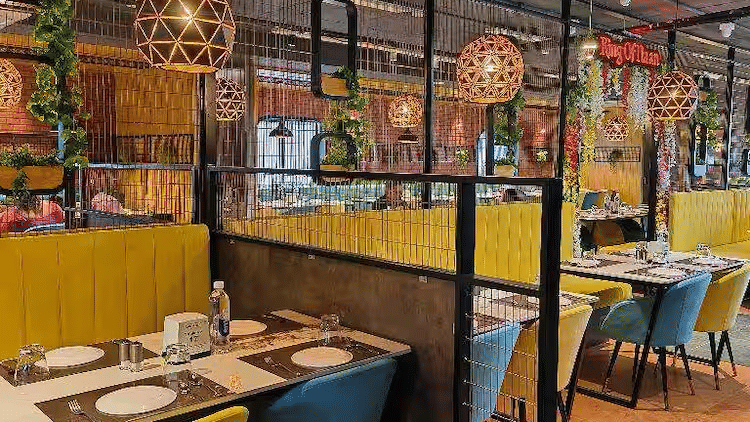 Colorful indoor dining space at Kake Da Hatti Whitefield