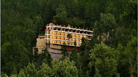 Facade of JK Clarks Exotica in Dalhousie amidst lush greenery