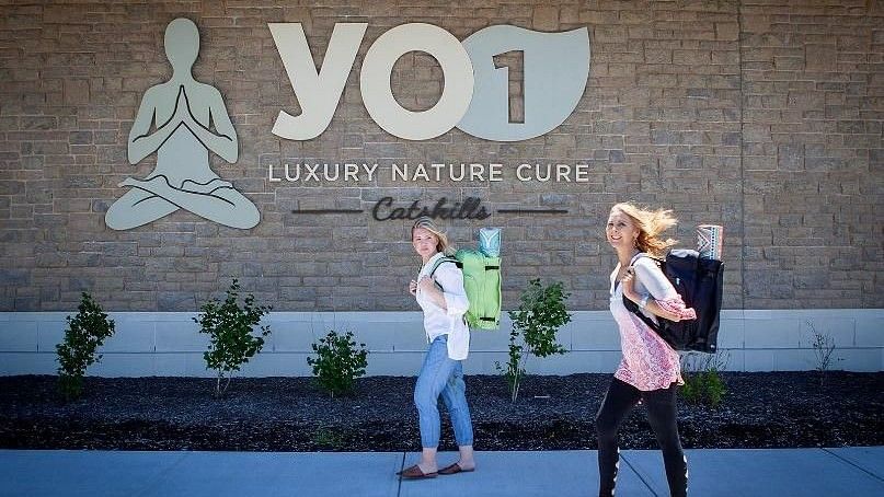 Yo1 signage in the background with 2 women walking seddr3