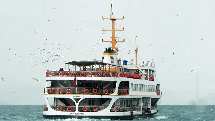 A ferry passing by in ocean. 