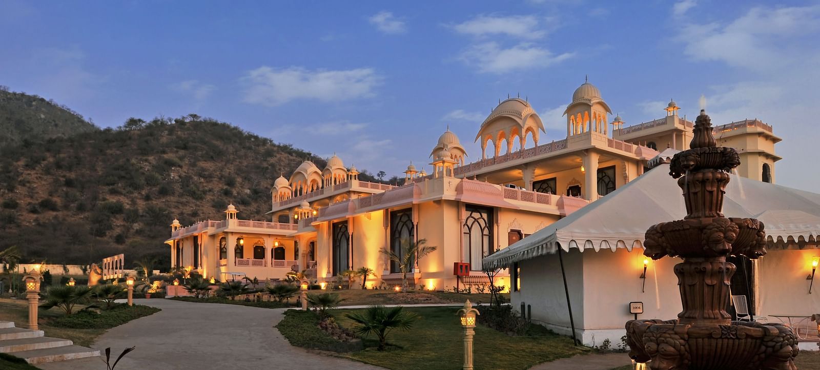 Facade of Rajasthali Resort & Spa Jaipur with a clear sky in the background.