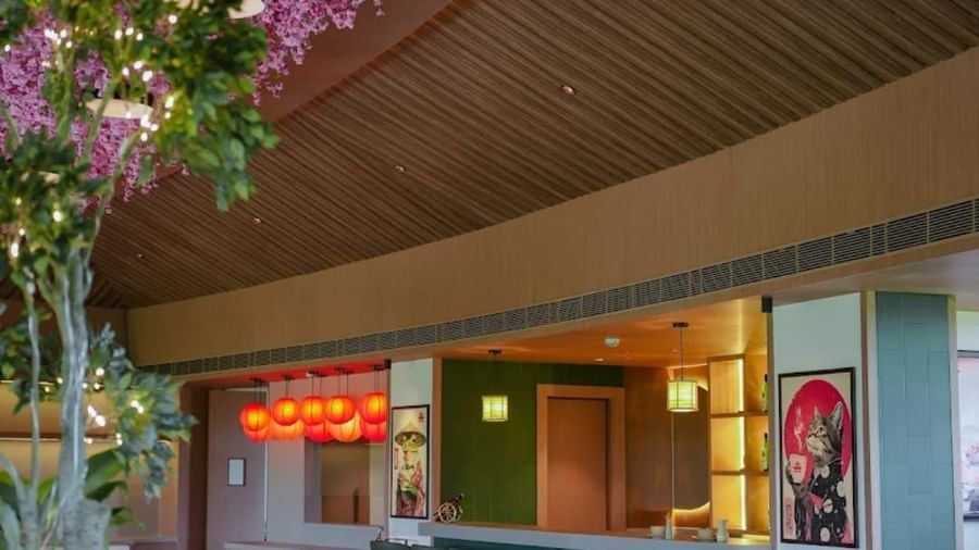 Seating area at Hanami Restaurant, Uday Suites, offering a cosy dining ambience with floral accents.