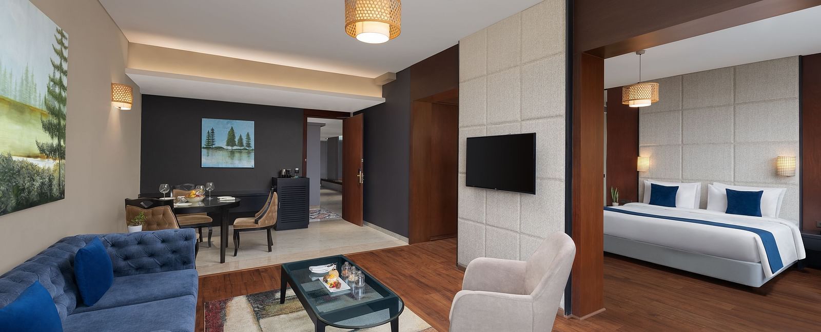 Living room area of Execuitve Suite at Essentia Luxury Hotel, Indore with sofa seating and coffee table set up.