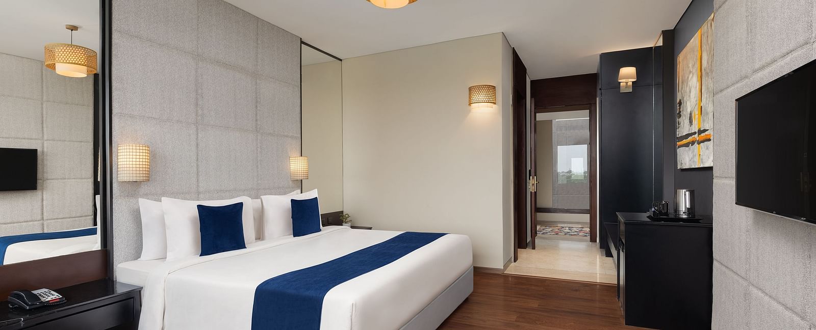 Premium Room at Essentia Luxury Hotel, Indore with a double bed and a television