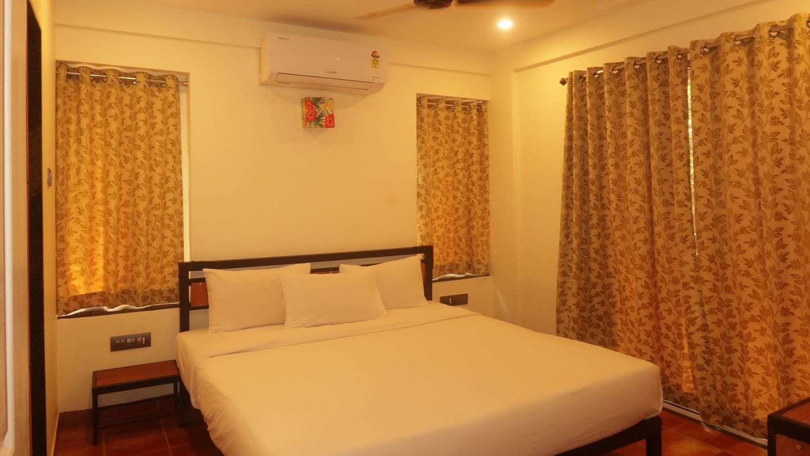 This comfortable bedroom at Forest Escape includes a double bed, bedside tables, and warm lighting for a restful stay.