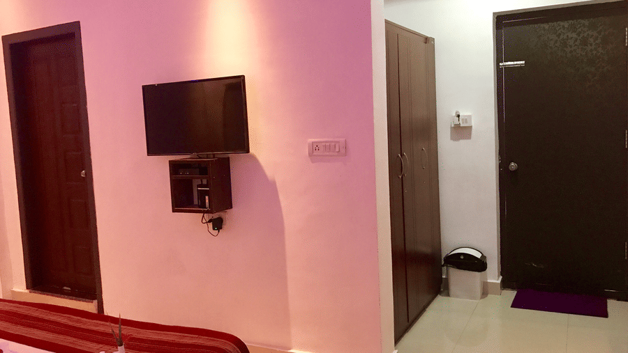 Image of a room with a television mounted on the wall at Coorg Jungle Camp Backwater Resort, Kushalnagar.