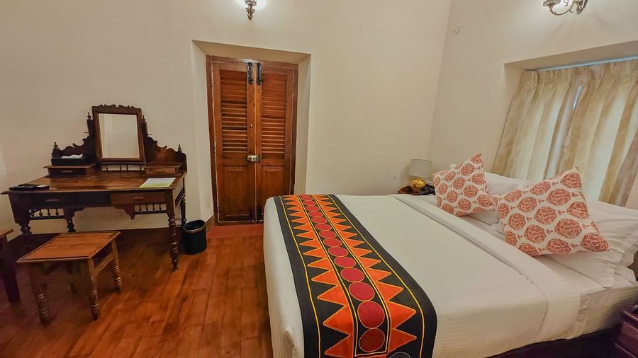 An overview of Strand bedroom with a plush double bed and other amenities - Ibex Stays & Trails, Coonoor (Leewood).