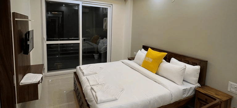 the interiors of the 2 bhk apartment with a king size bed