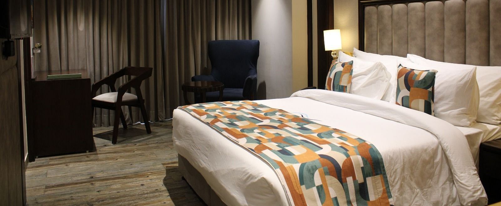A bedroom featuring working desk and chair at BluSalzz Residence, Amritsar