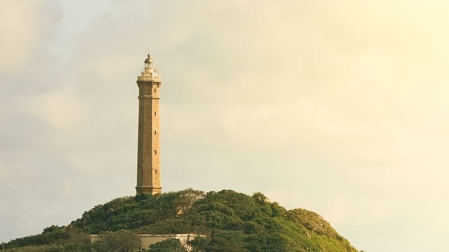 An overview of Ke Ga Lighthouse on Hon Ba Island with white clouds in the sky.