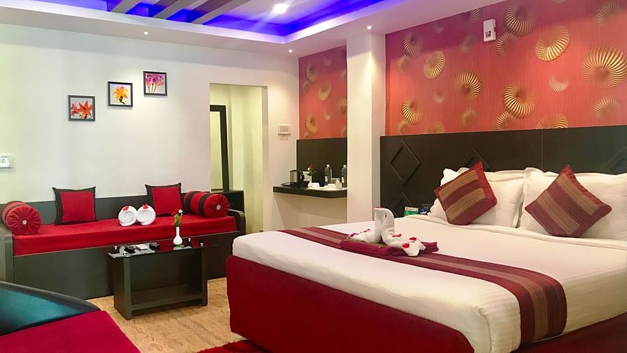 Image of a room with a bed decorated with towels and flower petals at Parampara Resort & Spa, Kushalnagar.
