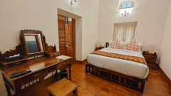 The interiors of Strand bedroom is with a plush double bed and other amenities - Ibex Resort, Coonoor (Leewood).