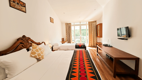 Side view of a Premium Room in Valparai with a balcony at Ibex Resort, the best resort in Valparai.