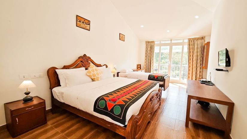 an image of twin beds in premium room with a balcony offering mountain views - Ibex Stays & Trails, Valparai (Mistly)