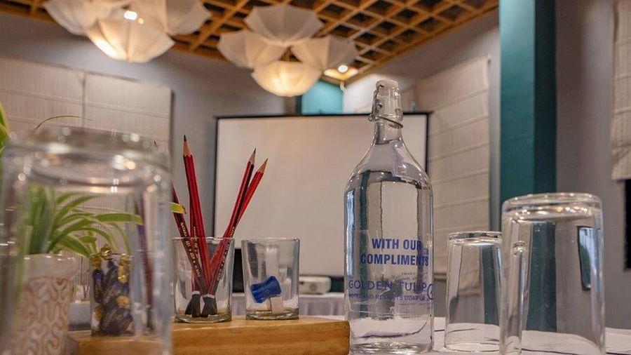 Hospitality tray setup with glasses, water bottles, and decor at Golden Tulip, Udaipur.