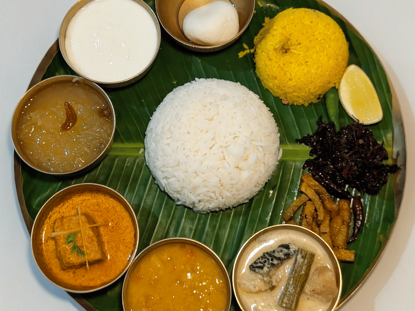 Indian vegetarian thali with rice, curries, and sweets at Dip Holidays.