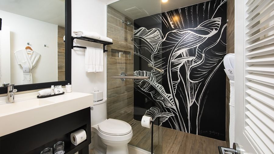 A hotel bathroom with ambient lighting, a separate shower area and a commode - S Hotel Montego Bay, Jamaica