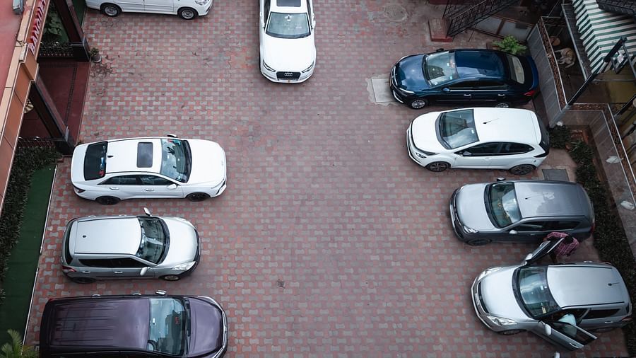 an aerial view image of the parking space at The Grand Krishna Rooms with a lot of cars parked 