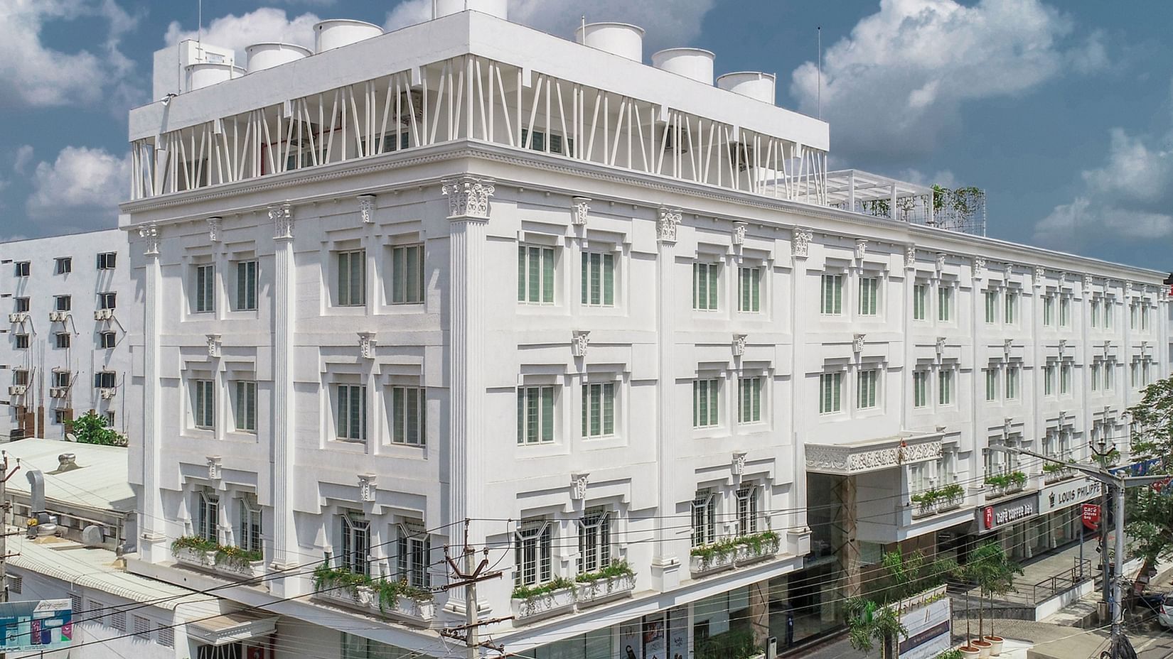 a bright facade image of the exterior of voyage annapurna de royal, guntur