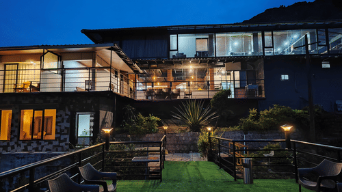 A night view of the facade of the resort with blue sky in the background 